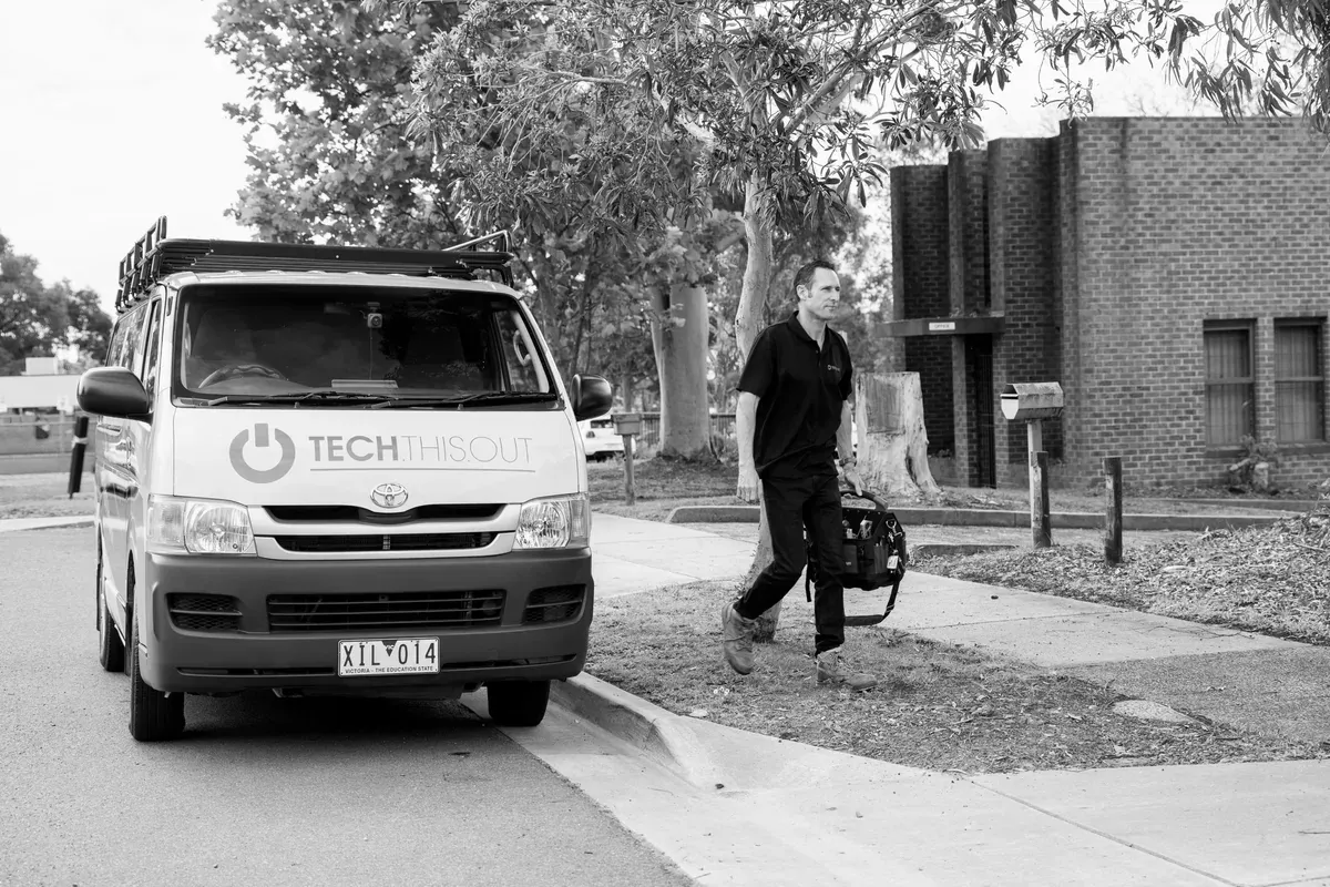 A Tech This Out technician arriving for an onsite job with the company van